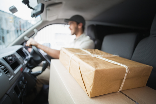 bigstock-Delivery-driver-driving-van-wi-71851240