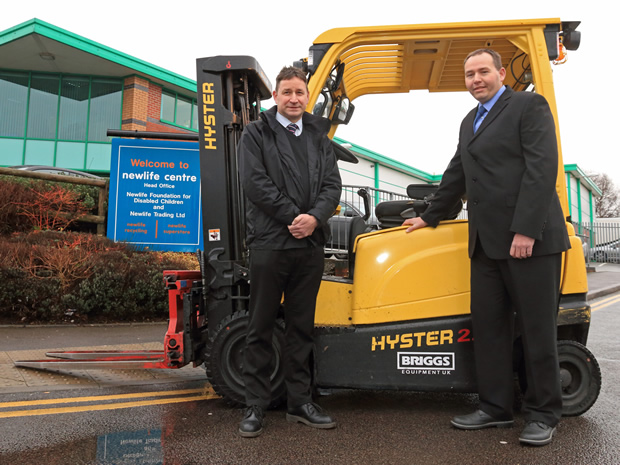 Tony Roper, Operations Manager at Newlife Trading (right), and Paul Robinson, Hyster Regional Sales Executive at Briggs Equipment, with one of the Hyster forklifts used to recycle goods donated by major UK retailers.