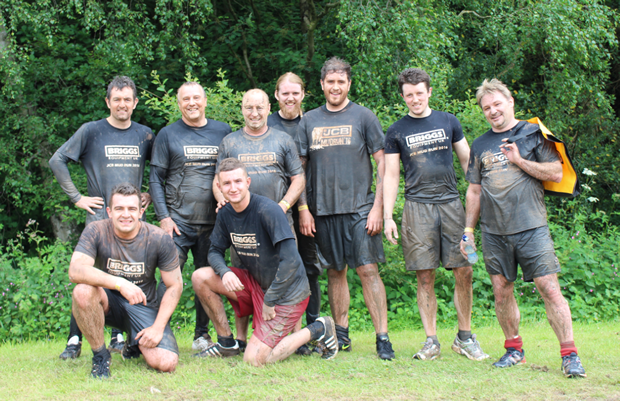 Members of staff from Briggs Equipment celebrate after completing the JCB Mud Run.