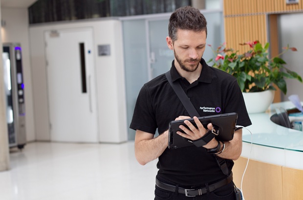 Performance Networks engineer using a tablet during a site survey